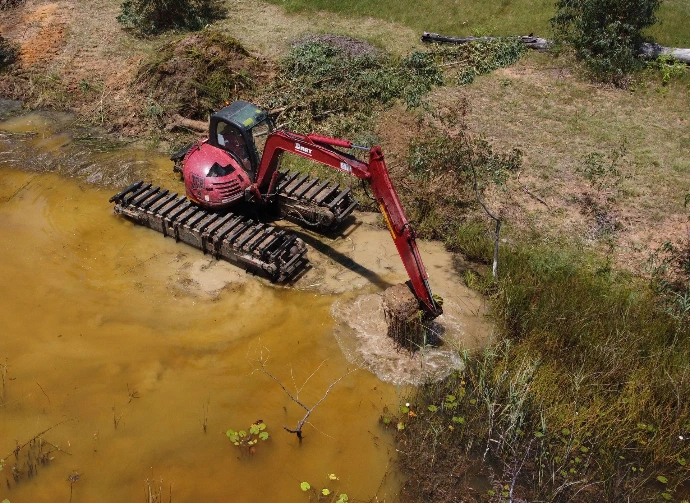 Amphibious Excavator removing silt